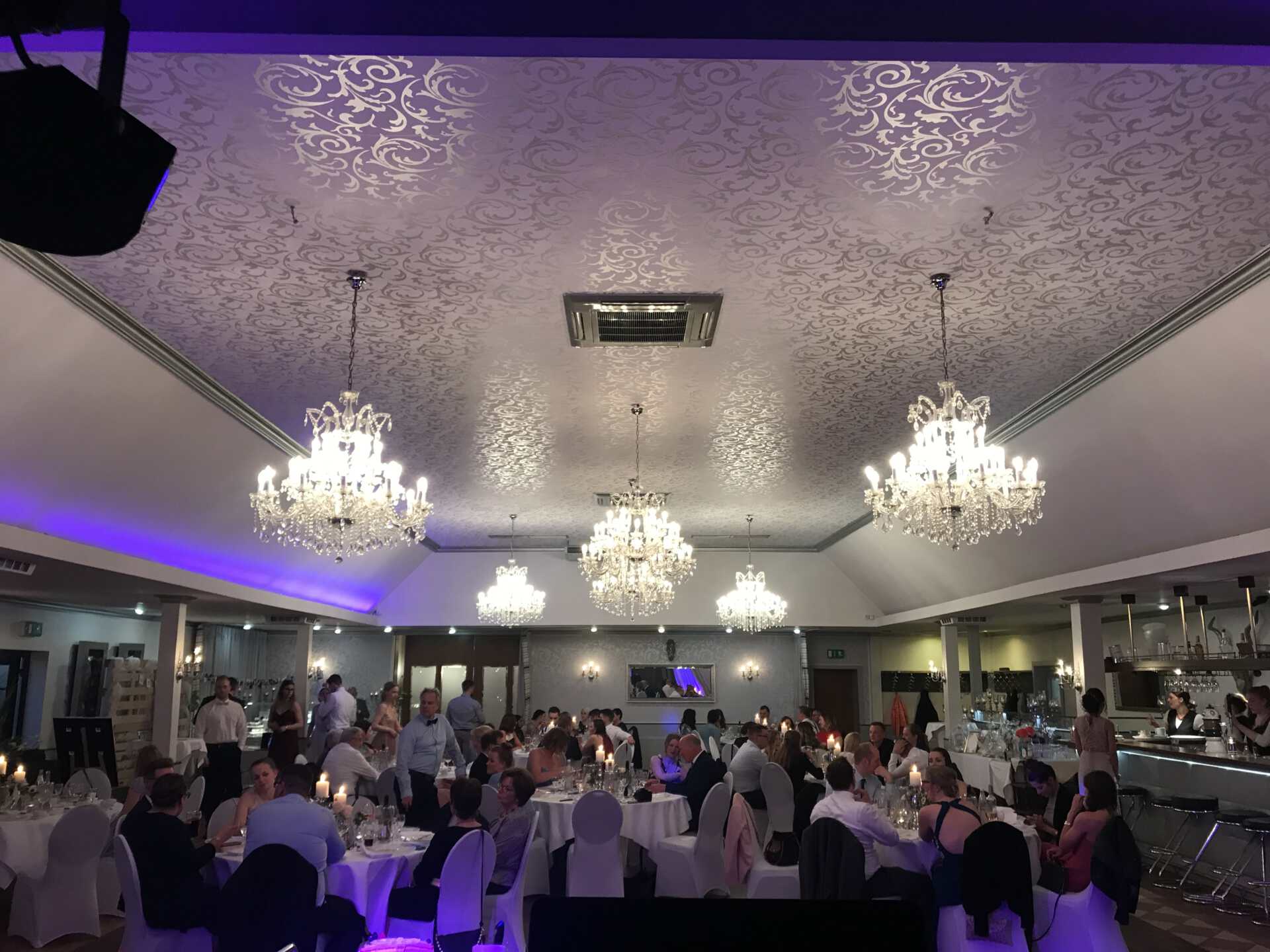 Hochzeitsgesellschaft im Festsaal mit Kronleuchtern